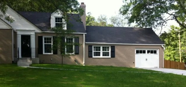 New white garage door system in one story house