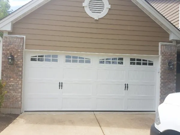 New white garage door system in one story house