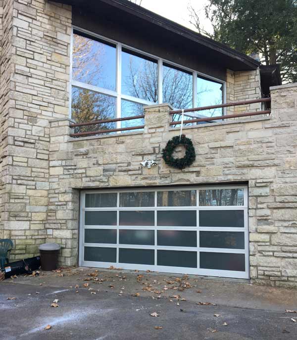 New white garage door system in one story house