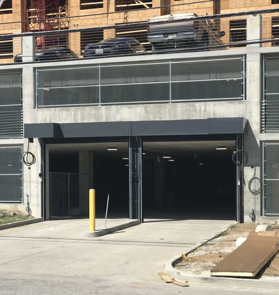 New black garage doors in parking lot