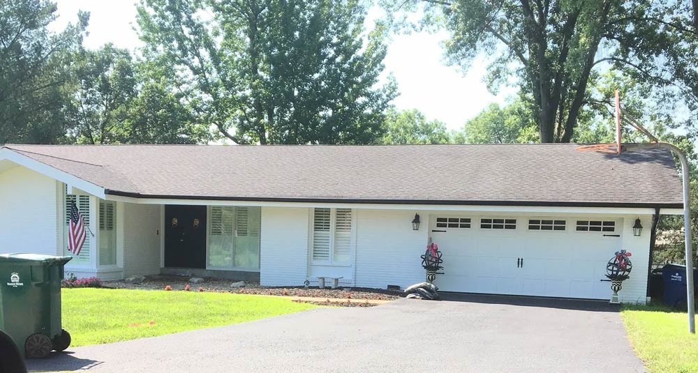 New white garage door system in one story house